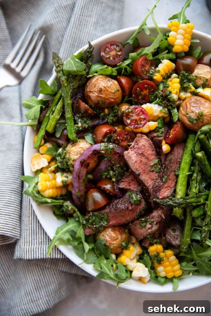 Chimichurri Steak & Roasted Vegetable Salad Recipe 3 steak salad with chimichurri asparagus corn tomatoes onion in a white bowl