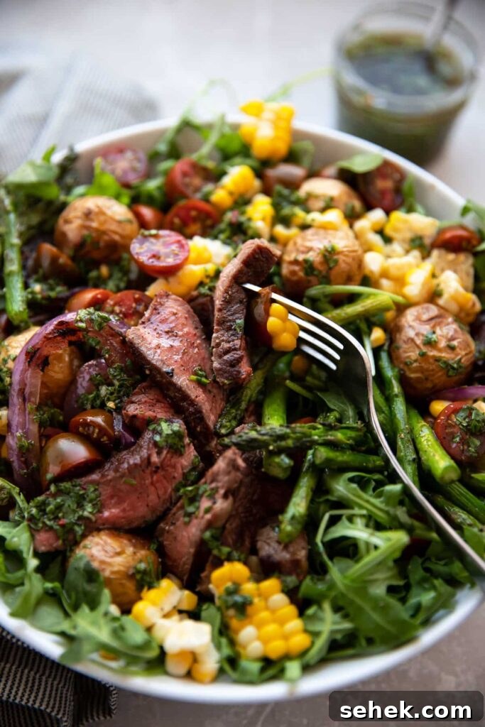 Chimichurri Steak & Roasted Vegetable Salad Recipe 4 steak salad with chimichurri asparagus corn tomatoes onion in a white bowl