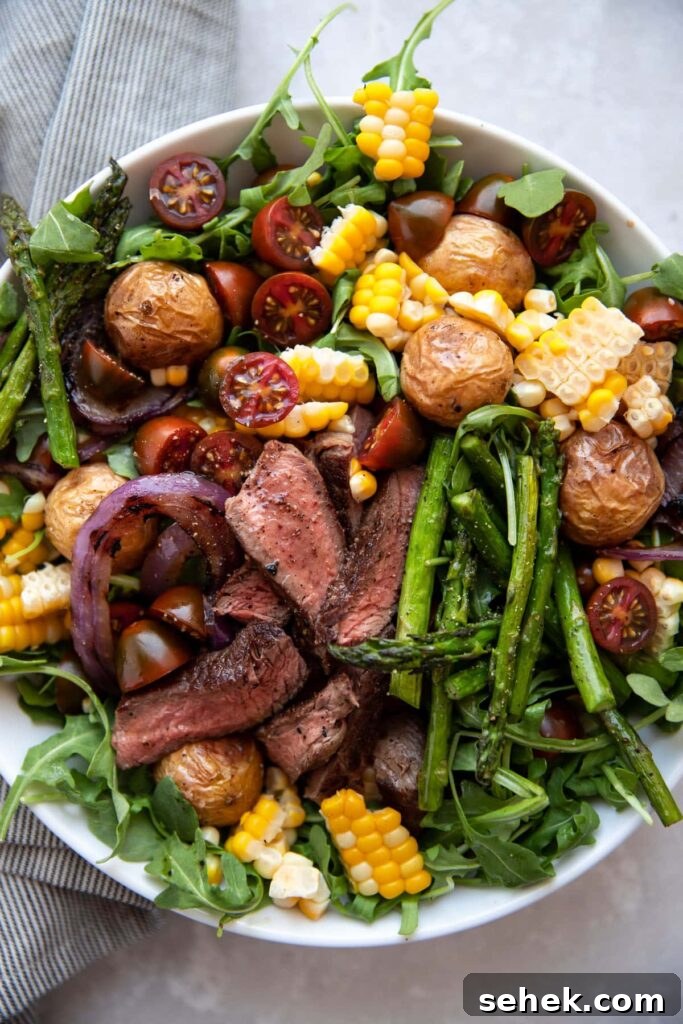 Chimichurri Steak & Roasted Vegetable Salad Recipe 5 steak salad with chimichurri asparagus corn tomatoes onion in a white bowl