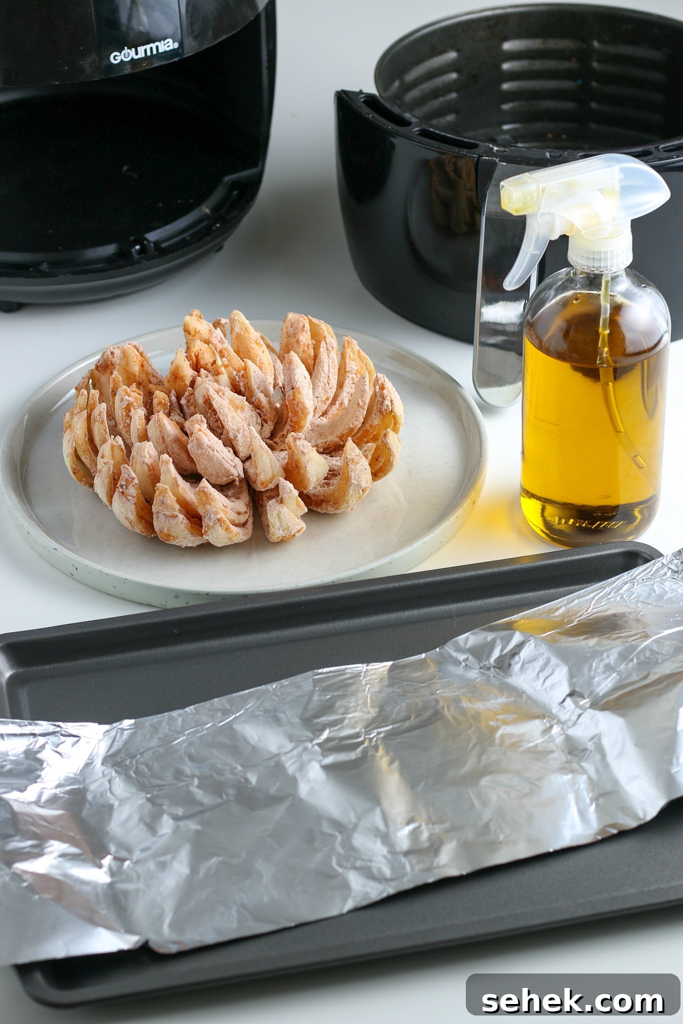 Crispy Air Fryer Blooming Onion Recipe for Perfect Appetizers 11 the dredged onion sitting on a plate in front of an air fryer