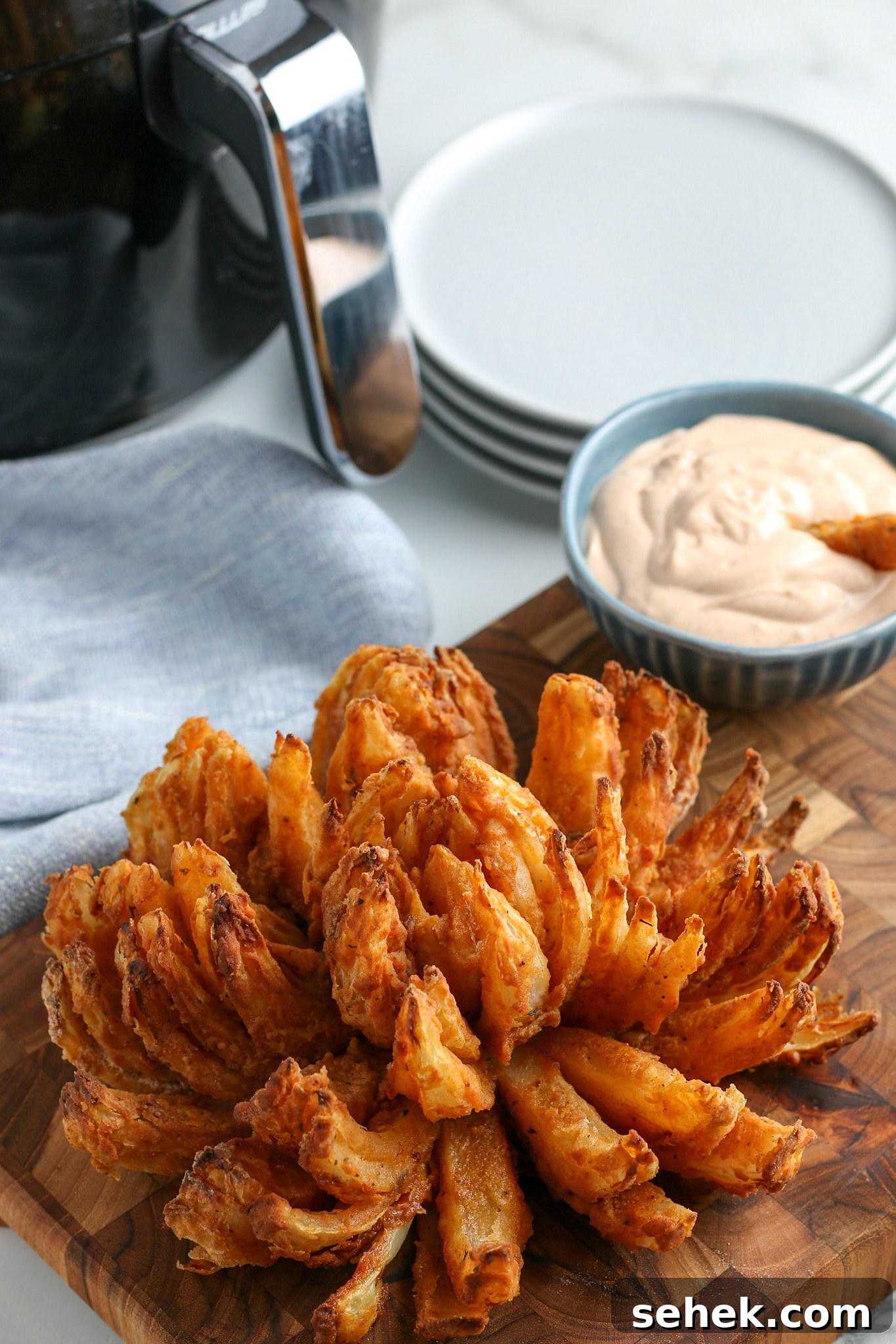 Crispy Air Fryer Blooming Onion Recipe for Perfect Appetizers 12 the finished air fried blooming onion recipe with horseradish sauce in the background.