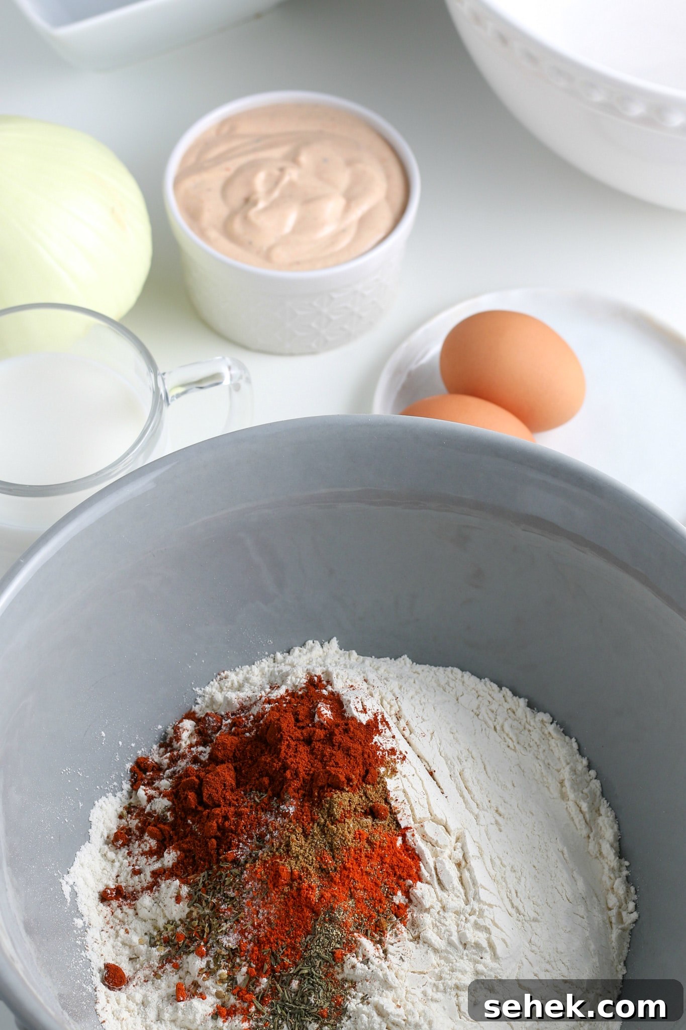 Crispy Air Fryer Blooming Onion Recipe for Perfect Appetizers 8 flour and spices in a large mixing bowl.
