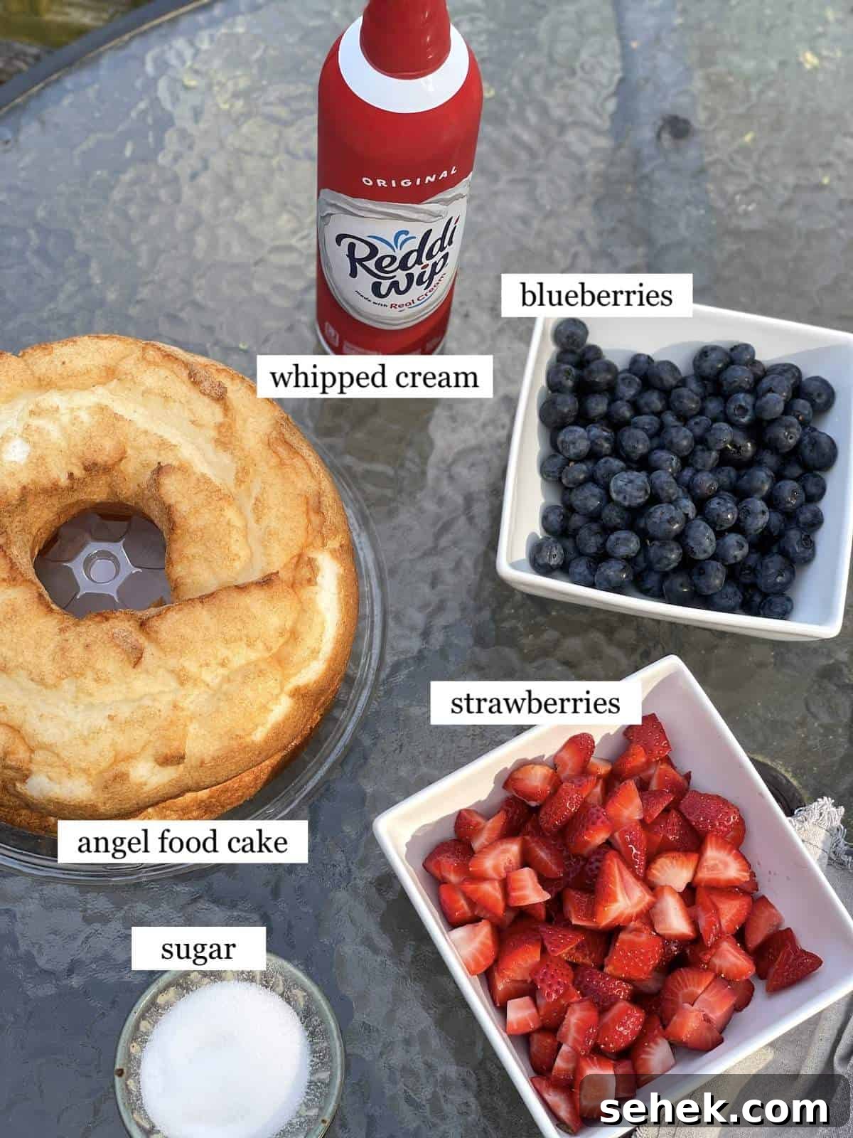 Strawberry Angel Food Shortcake with Fresh Whipped Cream 3 The ingredients in angel food cake strawberry shortcake laid out and labeled.