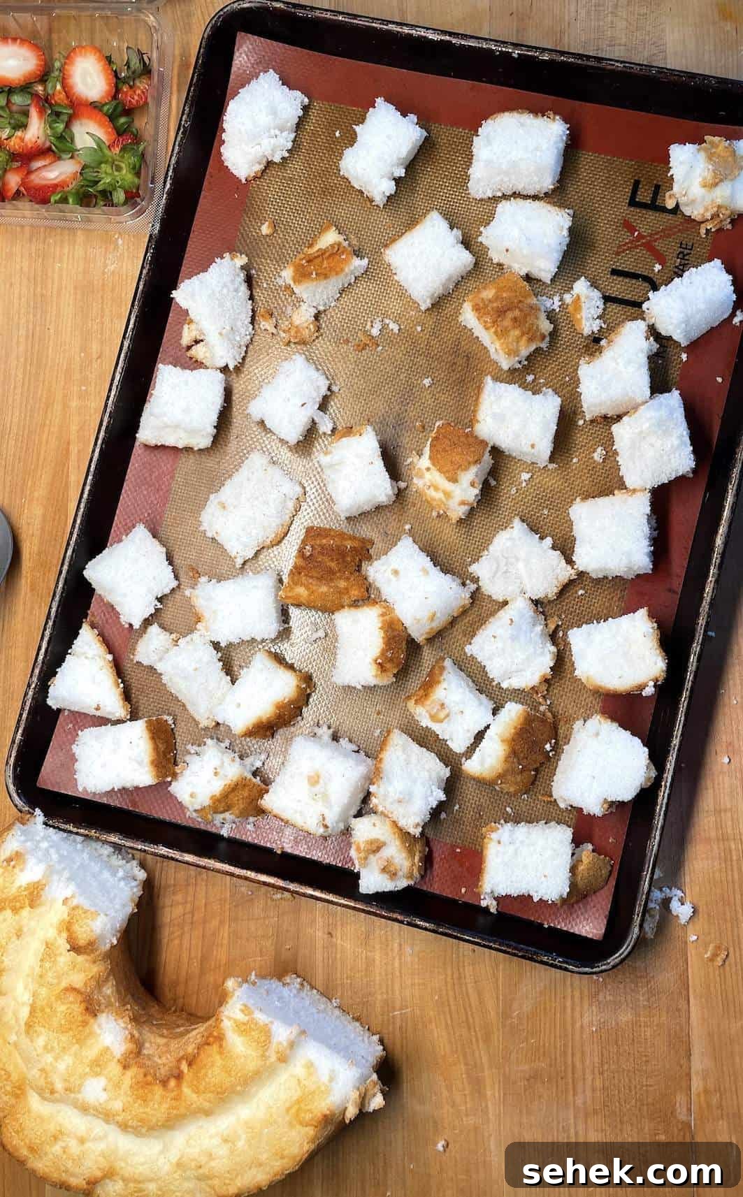 Strawberry Angel Food Shortcake with Fresh Whipped Cream 7 Angel food cake cut into cubes on a bake sheet before toasting to make shortcakes.