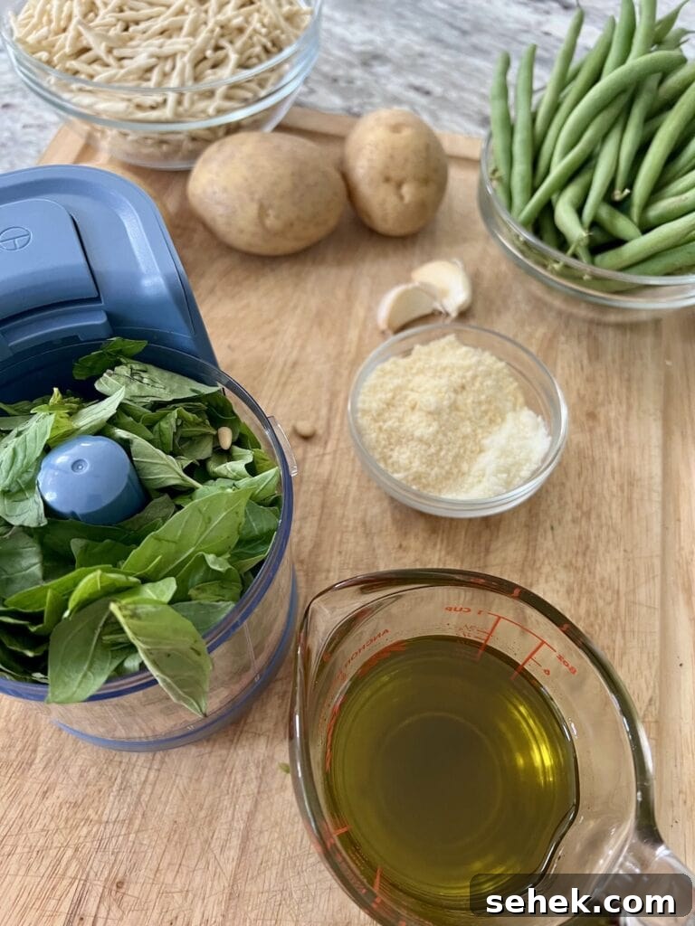 Trofie al Pesto Genovese with Potatoes and Green Beans 6 Getting ready to make pesto: basil in food processor surrounded by garlic, grated cheese and olive oil.