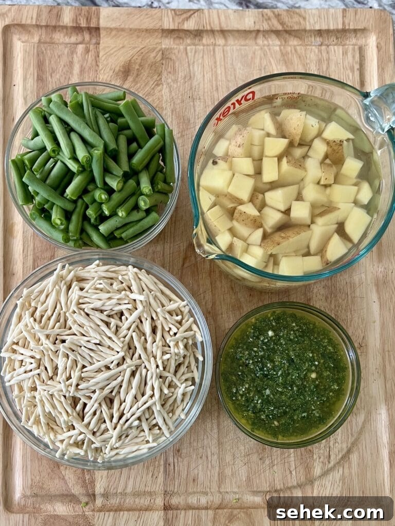 Trofie al Pesto Genovese with Potatoes and Green Beans 10 Prepped ingredients for trofie al pesto genovese on cutting board.