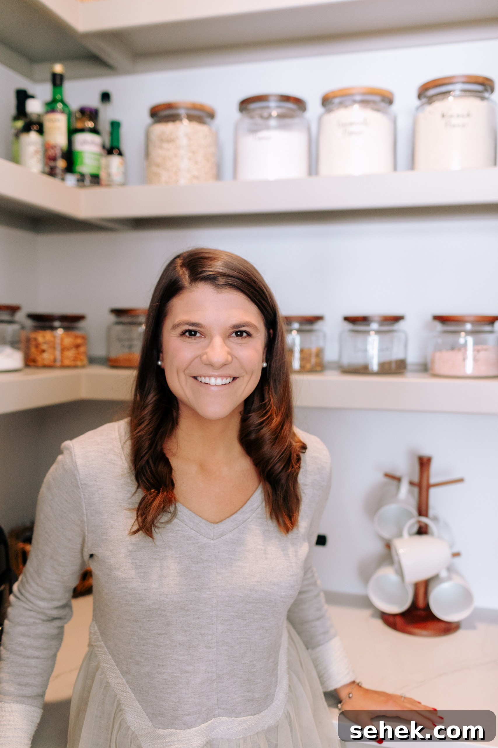 Kitchen Organization Guide: Smart Tips for a Tidy Kitchen 2 Allianna in the pantry with glass mason jars behind her.