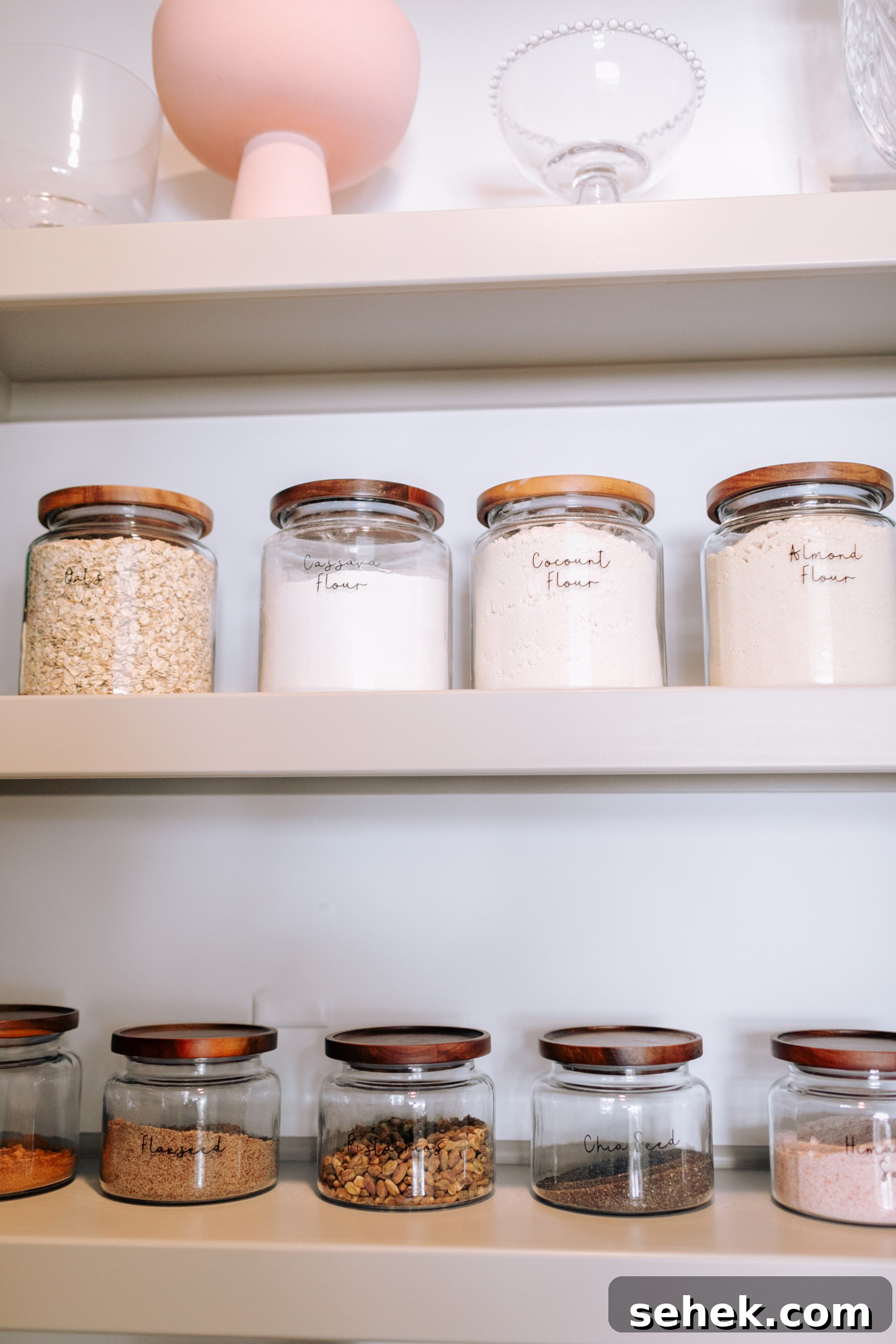 Kitchen Organization Guide: Smart Tips for a Tidy Kitchen 3 Glass pantry jars with wooden lids.