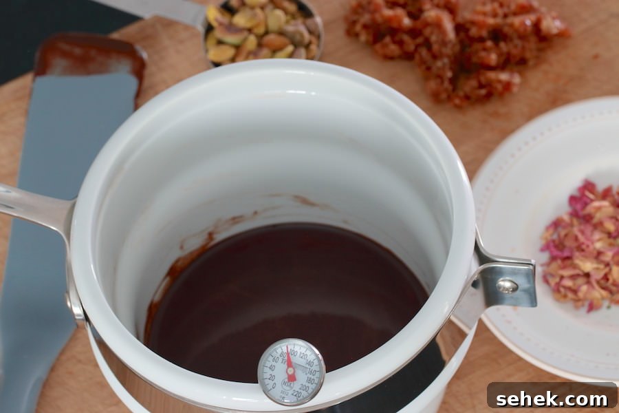 How to Make Rich Homemade Dark Chocolate at Home 5 Melted cocoa butter mixed with cacao powder; in the background minced dates, pistachios, and rose petals
