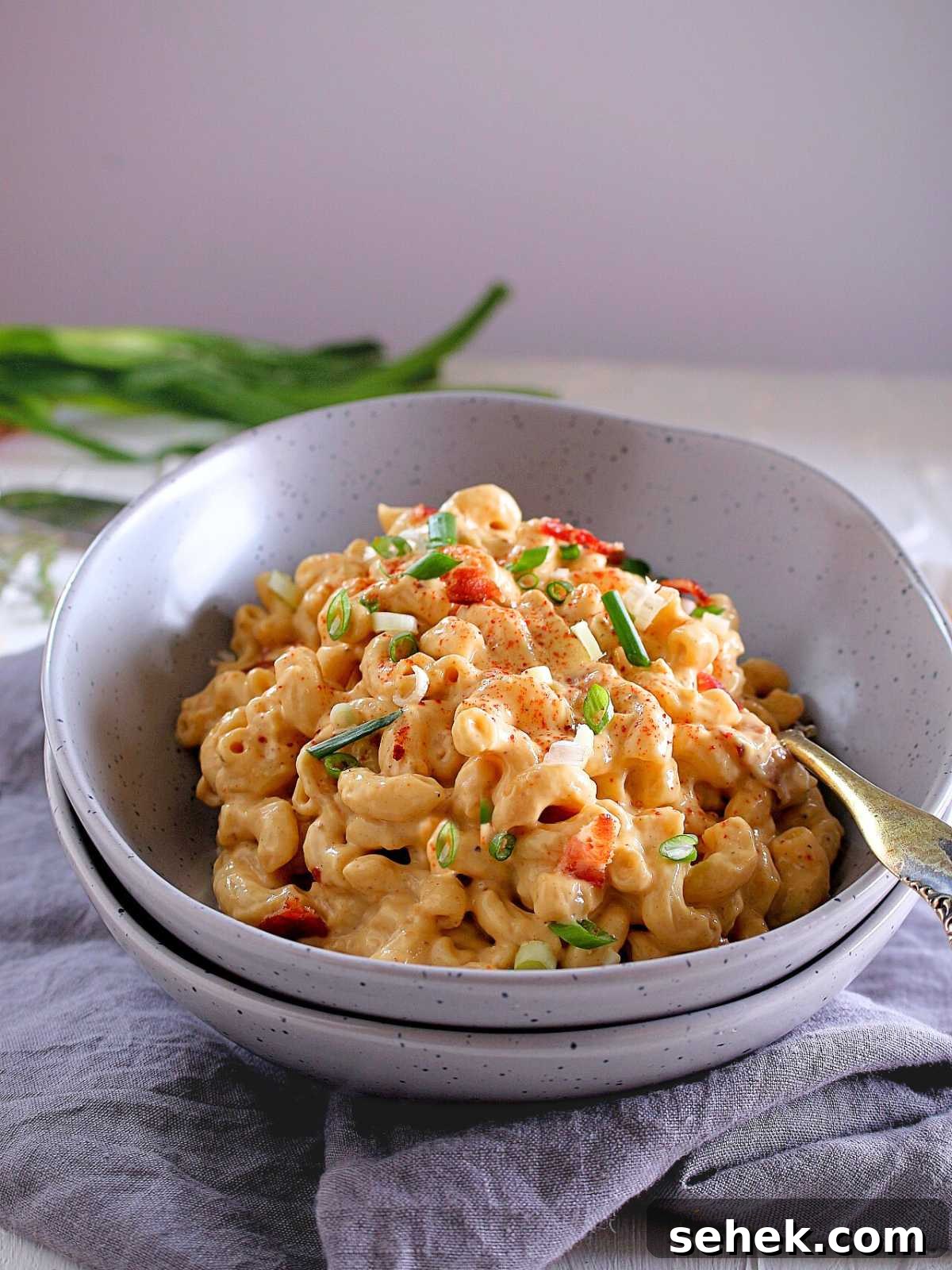 Creamy Cauliflower Mac and Cheese Bake for Comforting Meals 2 creamy cauliflower sauce with pasta in a bowl.
