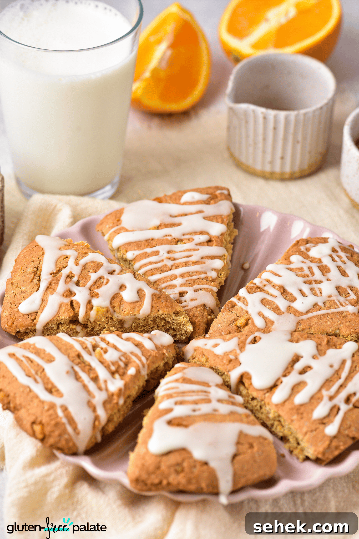 Gluten-Free Pumpkin Scones Recipe for Moist, Flaky Bakes 4 gluten-free pumpkin scones on a pink serving plate.