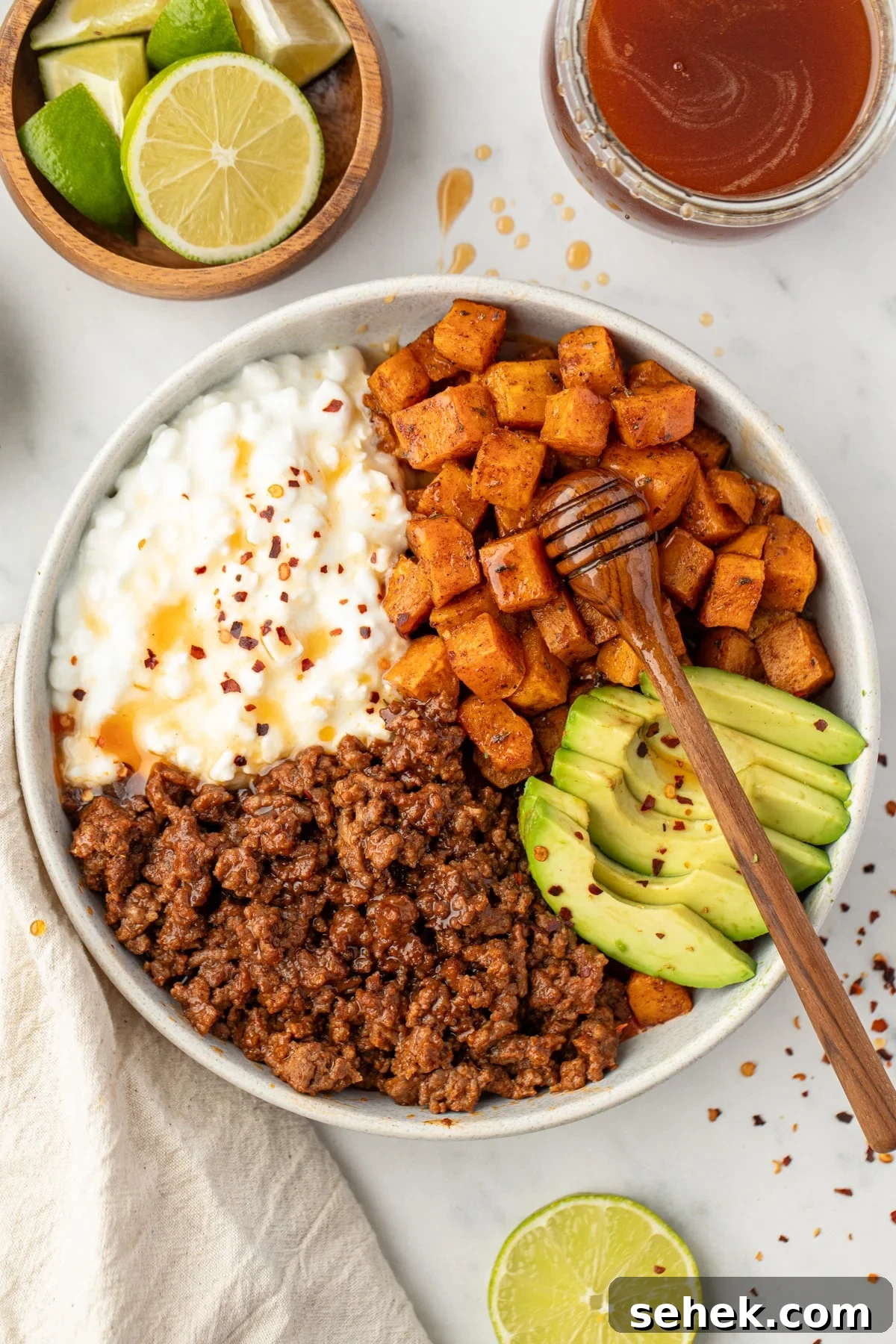 Spicy Honey Beef Bowls with Garlic Rice and Crispy Veggies 2 A bowl featuring sweet potatoes, cottage cheese, and ground beef.