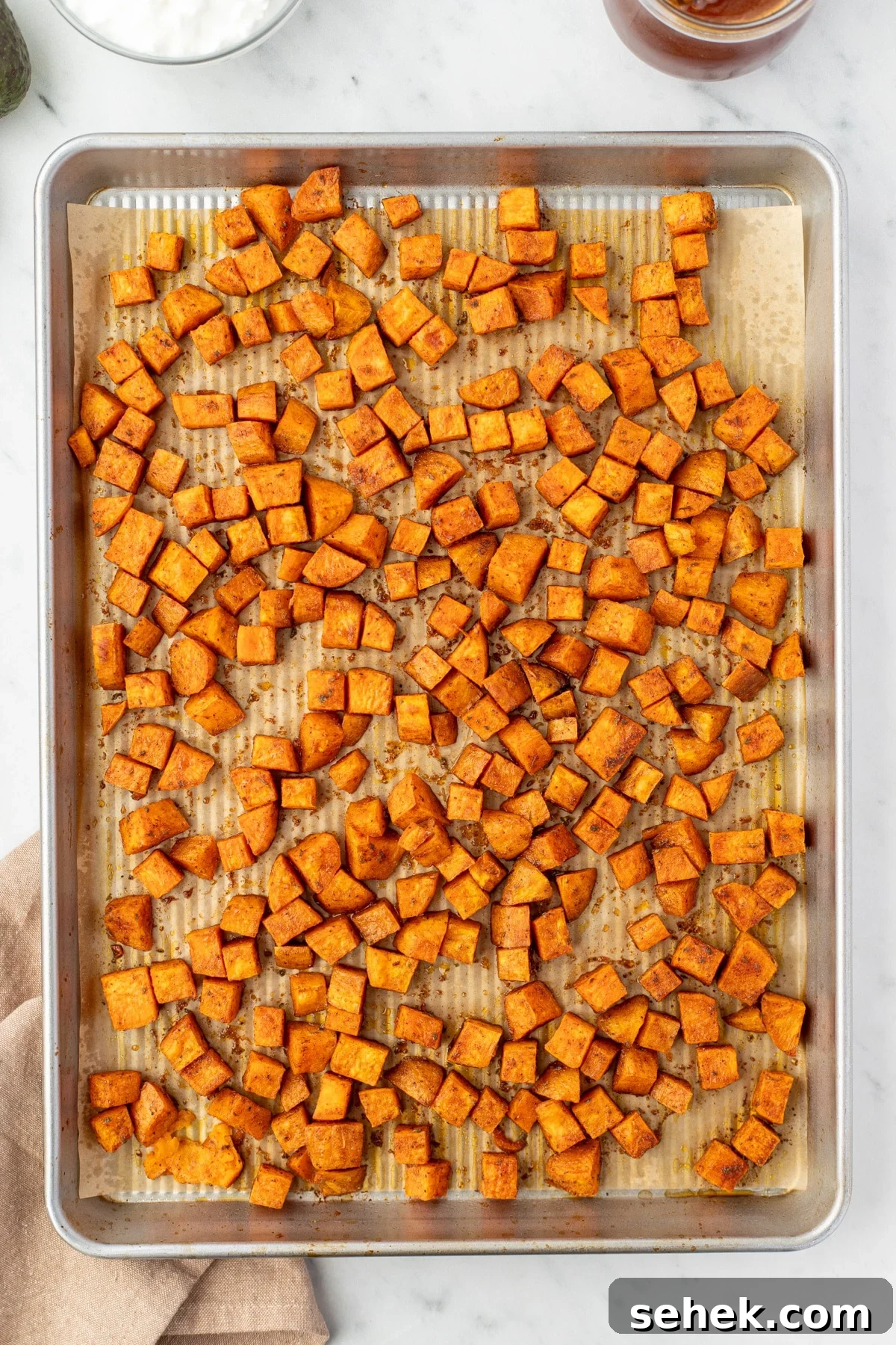 Spicy Honey Beef Bowls with Garlic Rice and Crispy Veggies 5 Roasted sweet potato cubes on a sheet pan.