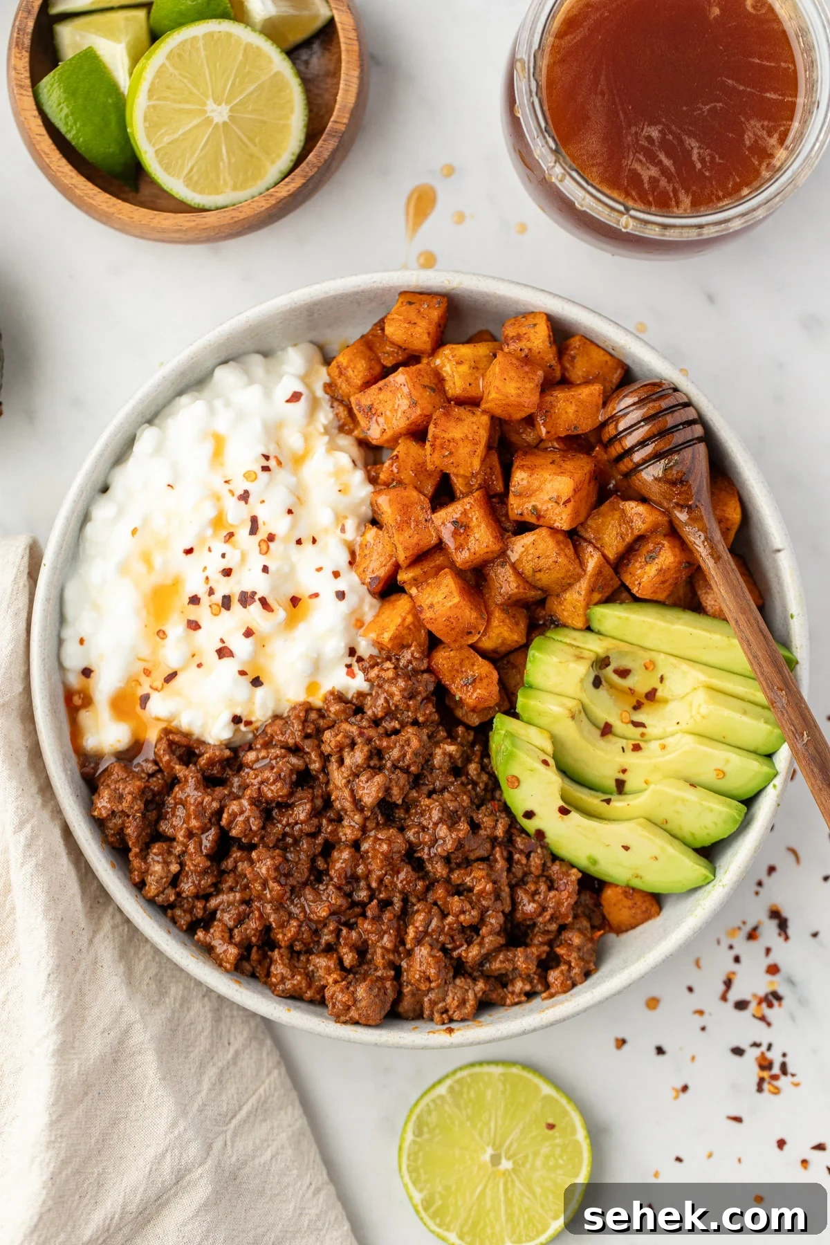 Spicy Honey Beef Bowls with Garlic Rice and Crispy Veggies 8 A bowl with ground beef, cottage cheese, and sweet potatoes.