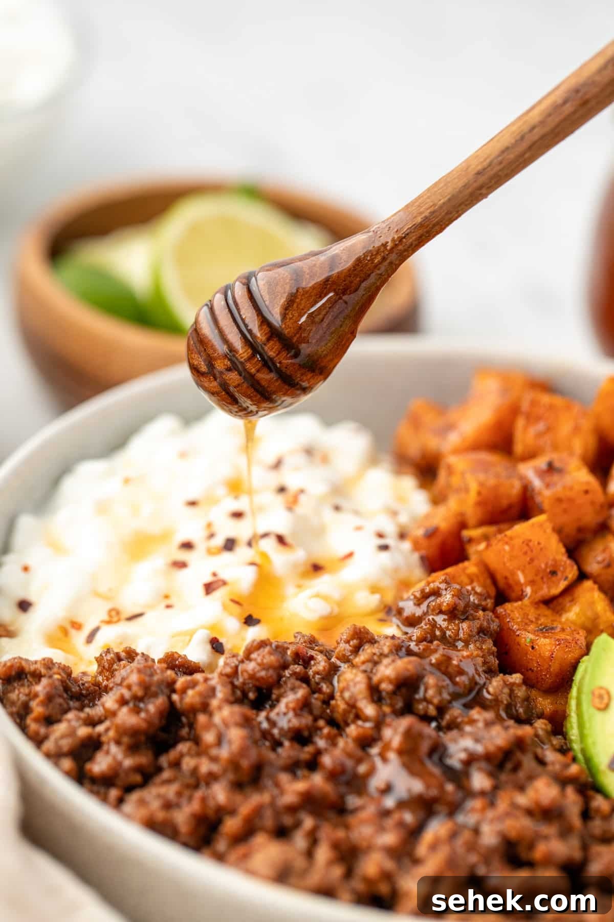 Spicy Honey Beef Bowls with Garlic Rice and Crispy Veggies 9 Drizzling honey on top of cottage cheese and seasoned ground beef.