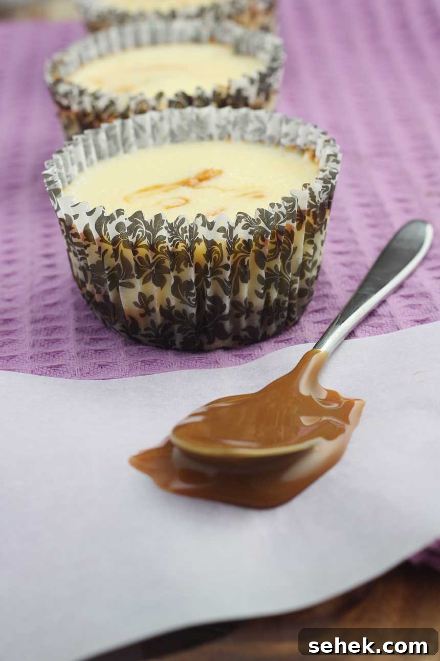Caramel Cupcake Cheesecakes: Mini Caramel Cheesecake Cupcakes 4 Caramel cupcake cheesecake on a purple tea towel with a spoon with caramel on it in front.