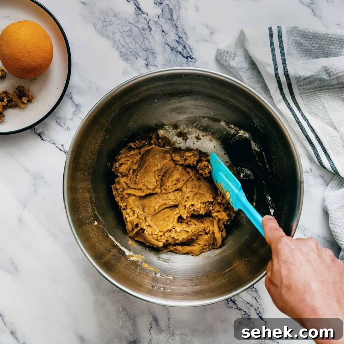 Melomakarona Greek Christmas Honey Cookies Recipe 8 mixing together the melomakarona dough.