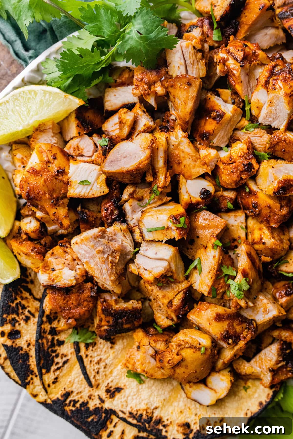 Chipotle-Style Pollo Asado Recipe: Juicy Mexican Grilled Chicken 13 Pollo Asado Recipe (Chipotle Copycat) cut in chunks with grilled tortillas