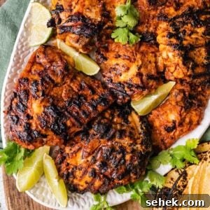 Chipotle-Style Pollo Asado Recipe: Juicy Mexican Grilled Chicken 18 Pollo Asado Recipe (Chipotle Copycat) made into a rice bowl with sides on a platter.