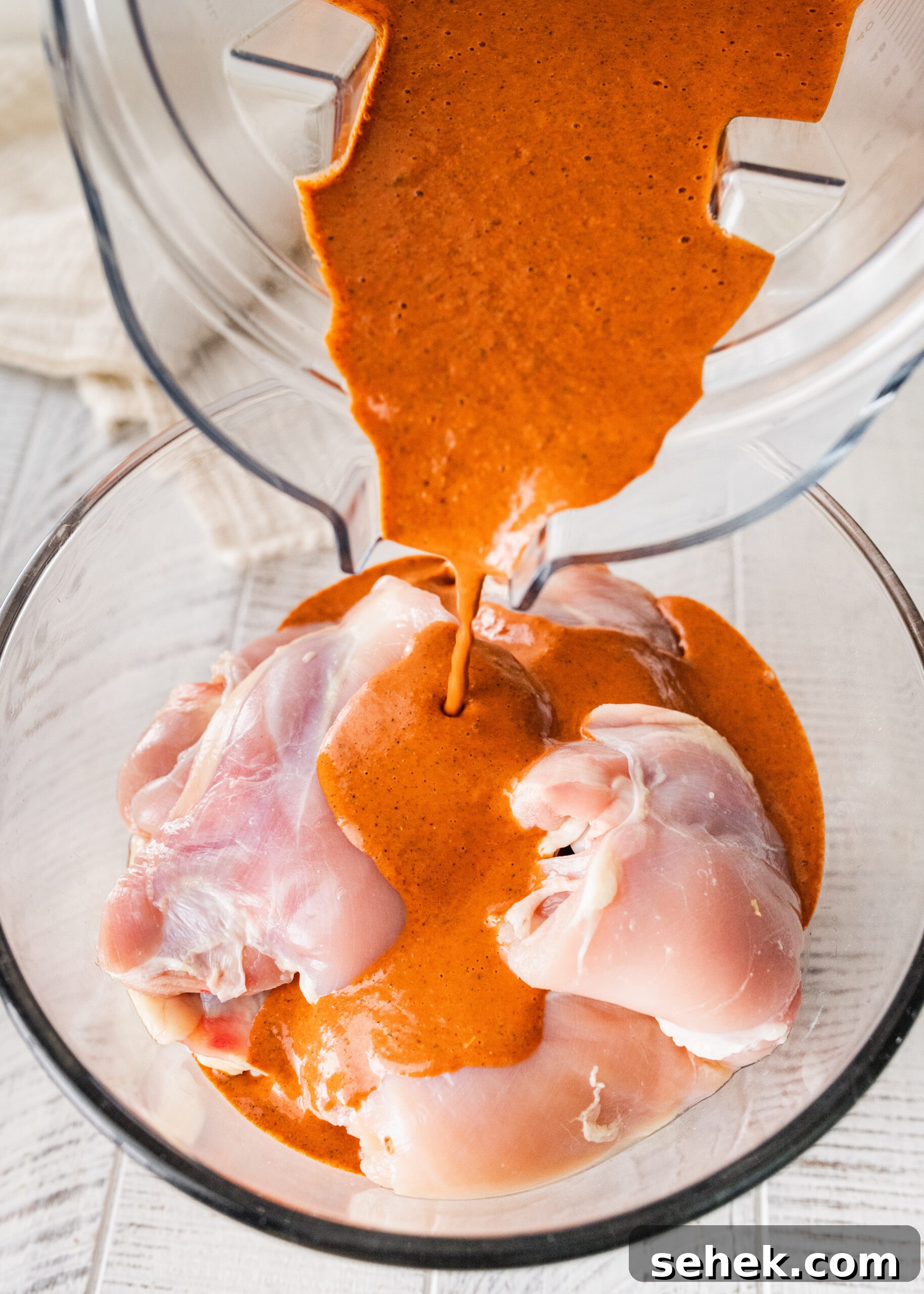Chipotle-Style Pollo Asado Recipe: Juicy Mexican Grilled Chicken 9 pouring sauce over chicken to marinade (process)