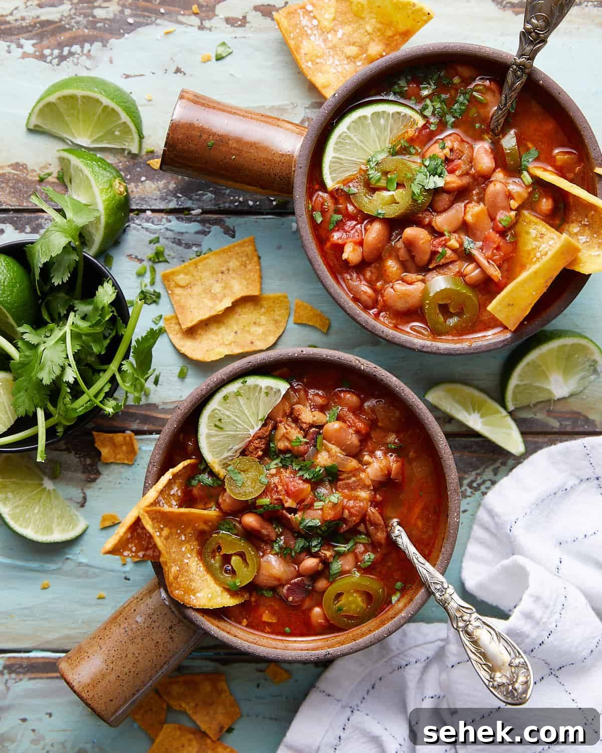 Instant Pot Charro Beans Recipe — Authentic Mexican Frijoles Charros 5 Overhead photo of instant pot charro beans in two bowls with garnish.