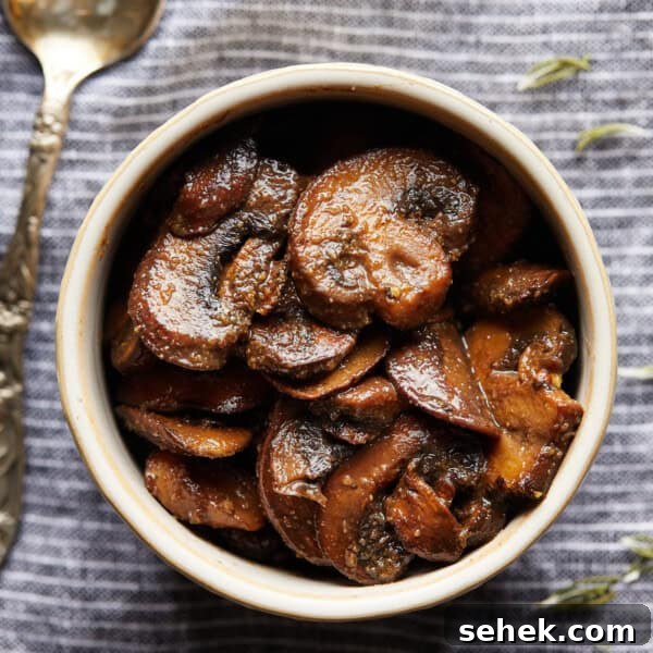 Instant Pot Charro Beans Recipe — Authentic Mexican Frijoles Charros 7 Overhead photo of browned sliced mushrooms in a small bowl on a striped cloth.