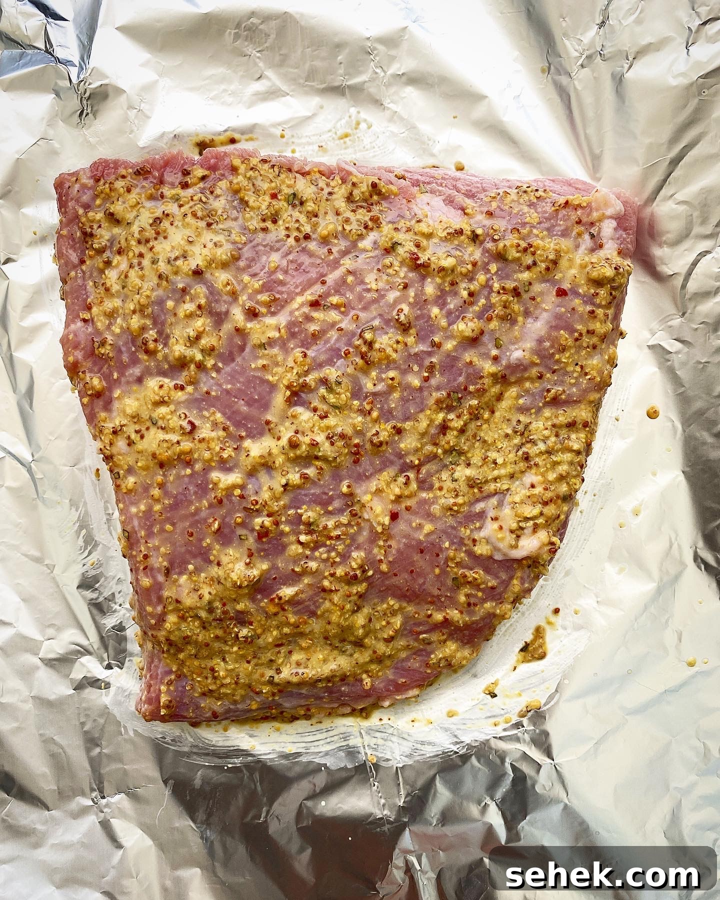 Crispy Air Fryer Corned Beef Recipe (With Video) 4 uncooked corned beef with mustard mixture on top in the air fryer