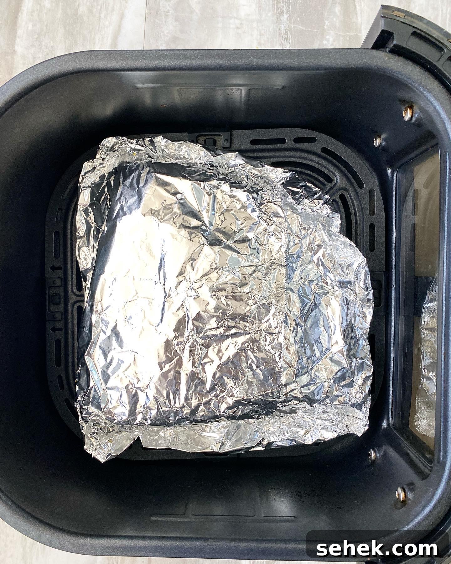 Crispy Air Fryer Corned Beef Recipe (With Video) 5 uncooked corned beef wrapped in foil in the air fryer