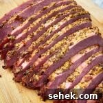 cooked & sliced corned beef on a cutting board