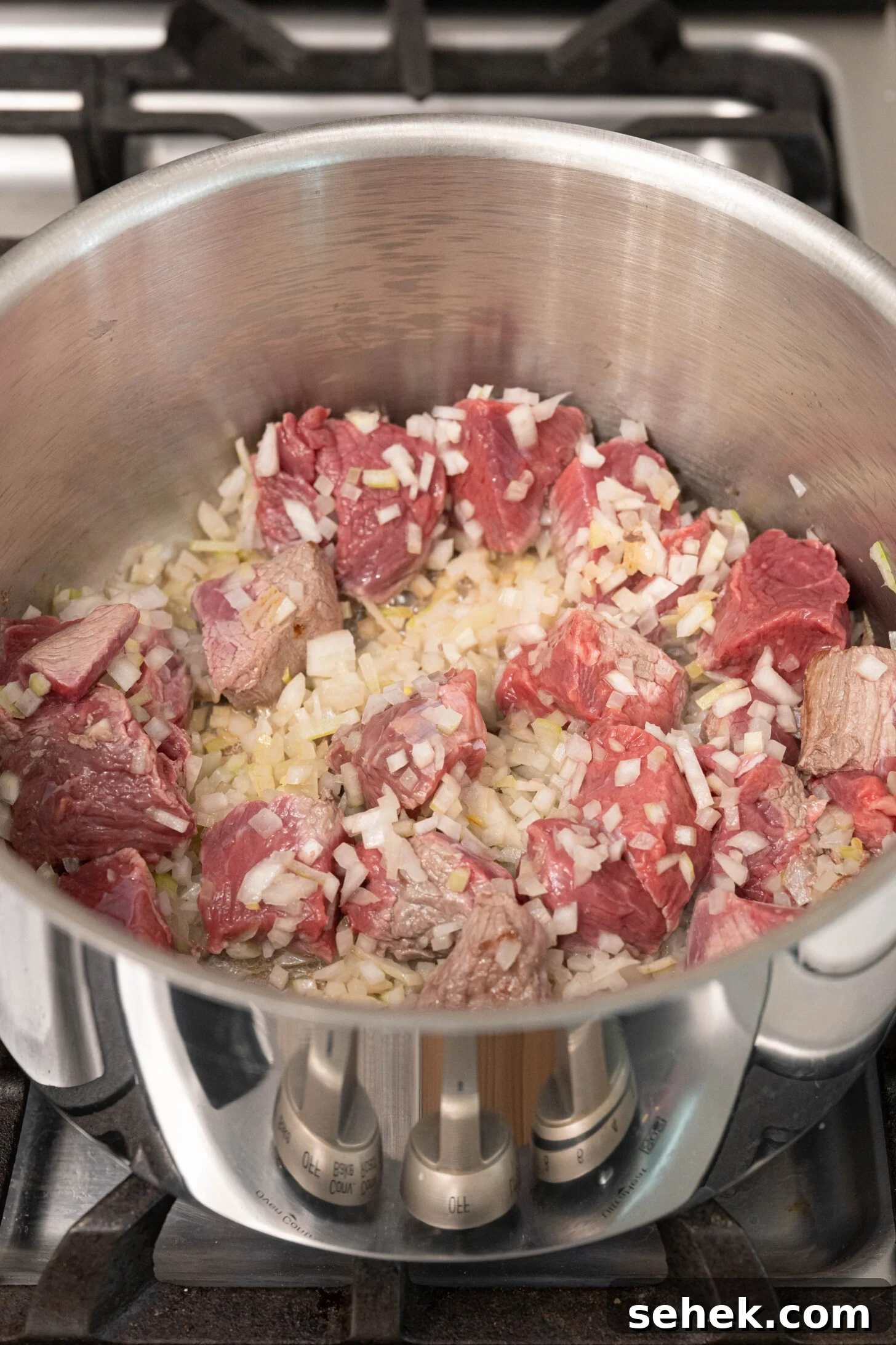 Moroccan Lamb and Orzo Recipe with Warm Spices 4 a pot with lamb and onions sautéing