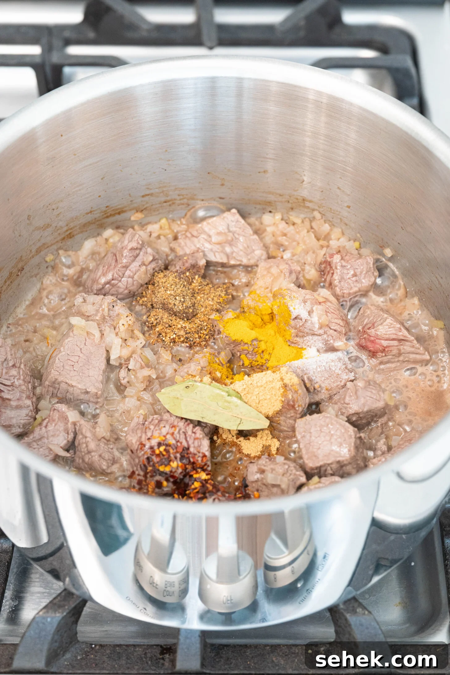Moroccan Lamb and Orzo Recipe with Warm Spices 5 a pot with lamb, onions and spices sautéing