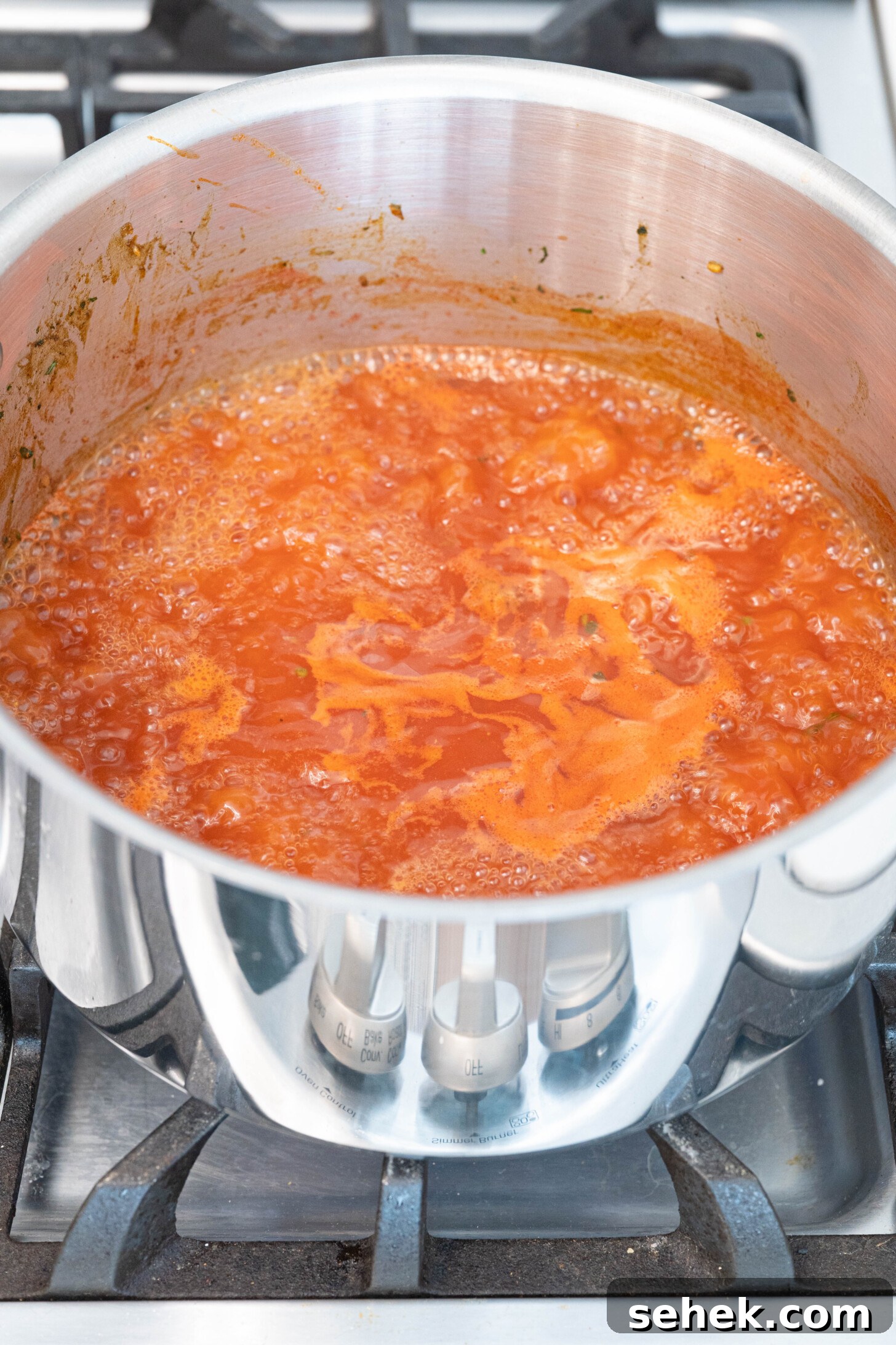 Moroccan Lamb and Orzo Recipe with Warm Spices 7 a pot of tomato sauce and water boiling