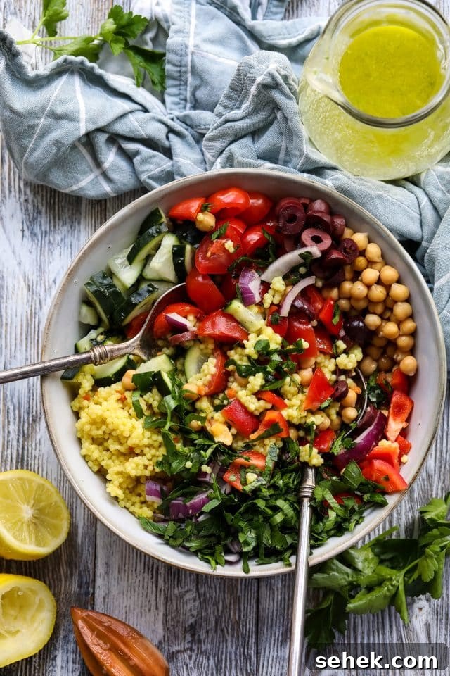 Vibrant Vegan Couscous Salad with Roasted Veggies and Herbs 4 Mixing vegan couscous salad with lemon garlic dressing.