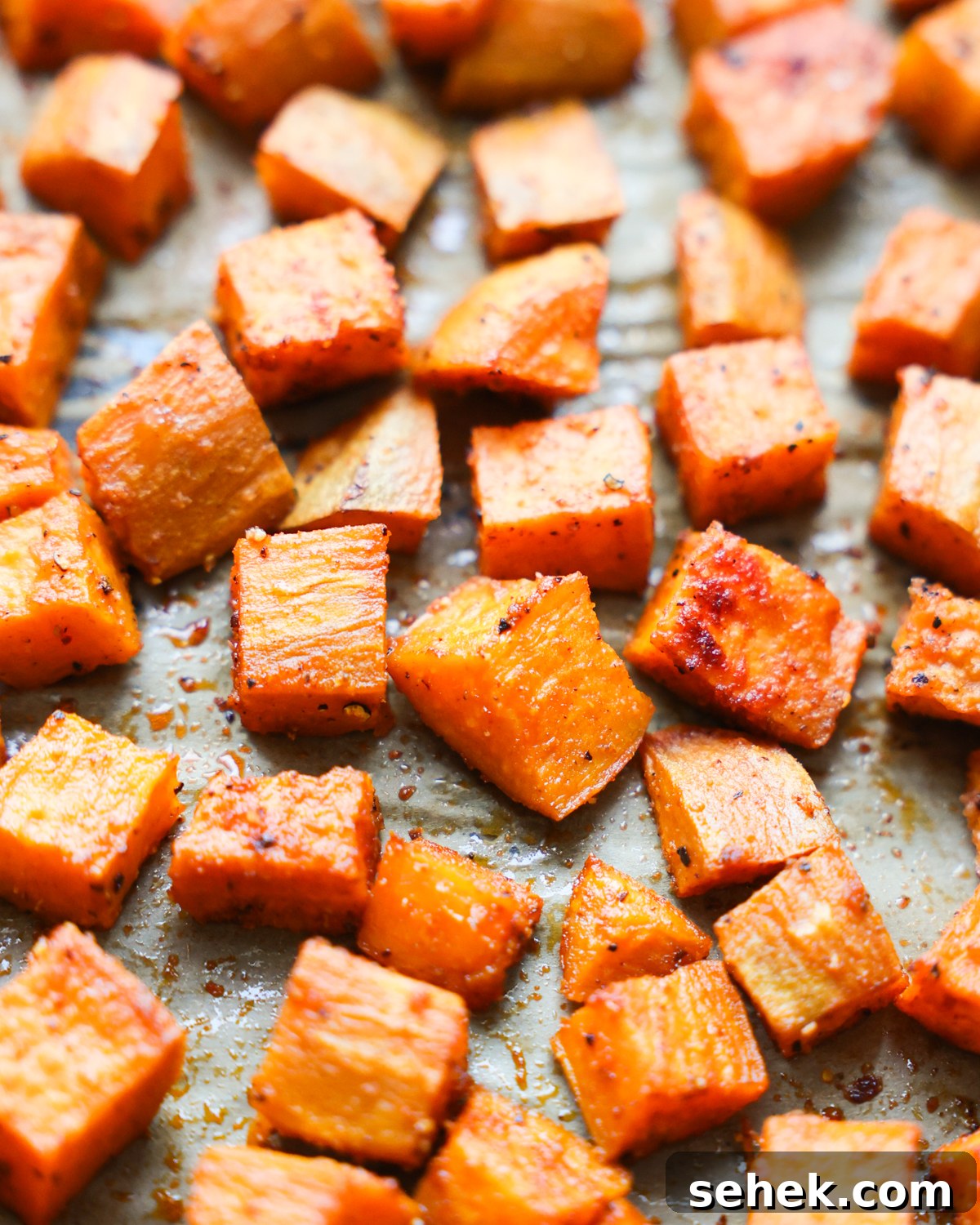 Perfectly Roasted Sweet Potatoes: Crispy Edges & Tender Centers 2 roasted sweet potatoes on parchment