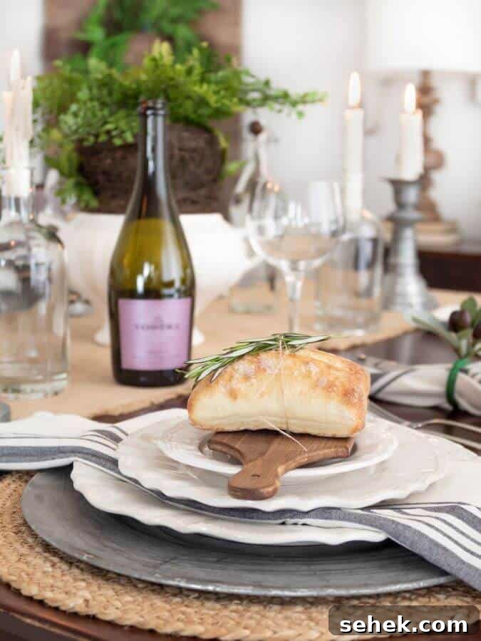Italian-Inspired Tablescape Ideas for Elegant Dinner Parties 10 place setting on table with wood bread board and bread on top