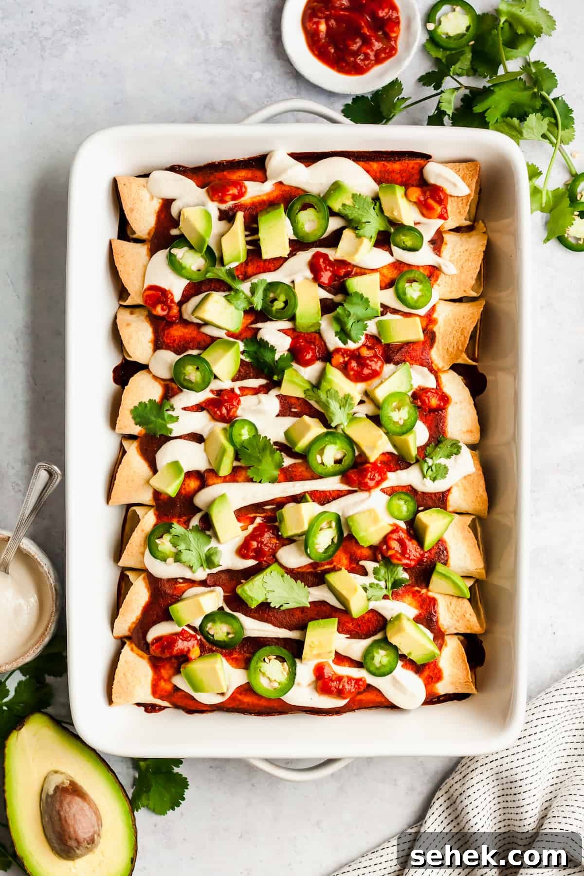 Vegan Black Bean and Kale Enchiladas Recipe for Flavorful Dinner 2 baking dish of enchiladas with avocado