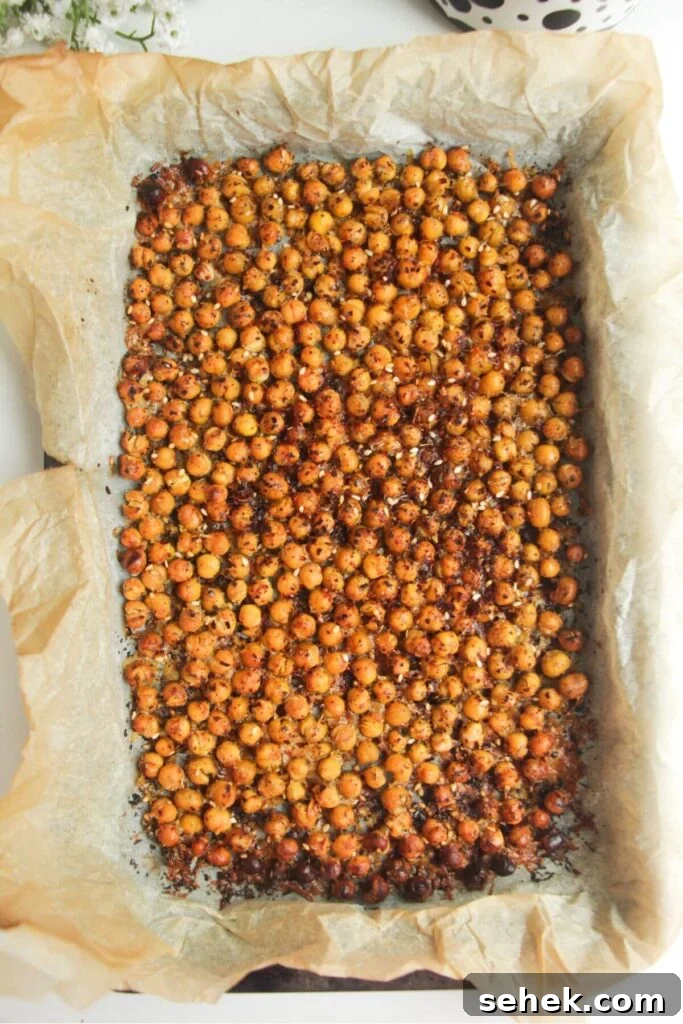 Crispy chickpeas in a baking paper lined tray.