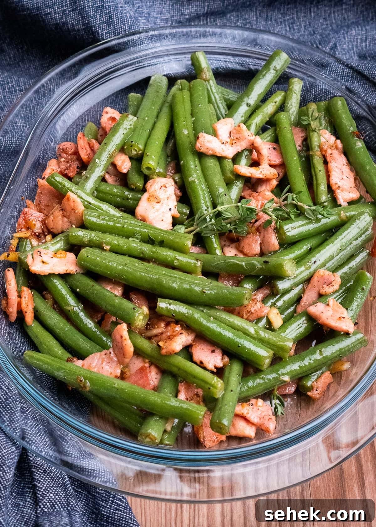 Garlic Green Beans with Crispy Bacon and Lemon Zest 2 Garlicky Green Beans and Bacon served in a glass dish