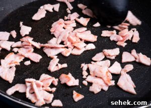 Garlic Green Beans with Crispy Bacon and Lemon Zest 9 Frying chopped up bacon in a frying pan
