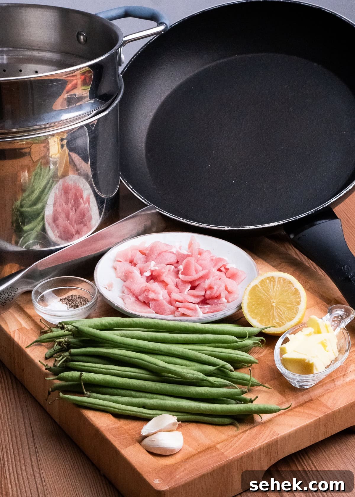 Garlic Green Beans with Crispy Bacon and Lemon Zest 15 Two garlic cloves, butter in a glass dish, salt , pepper , green beans, chopped up bacon, half a lemon a wooden board, large frying pan,,Sharpe knife and a steamer