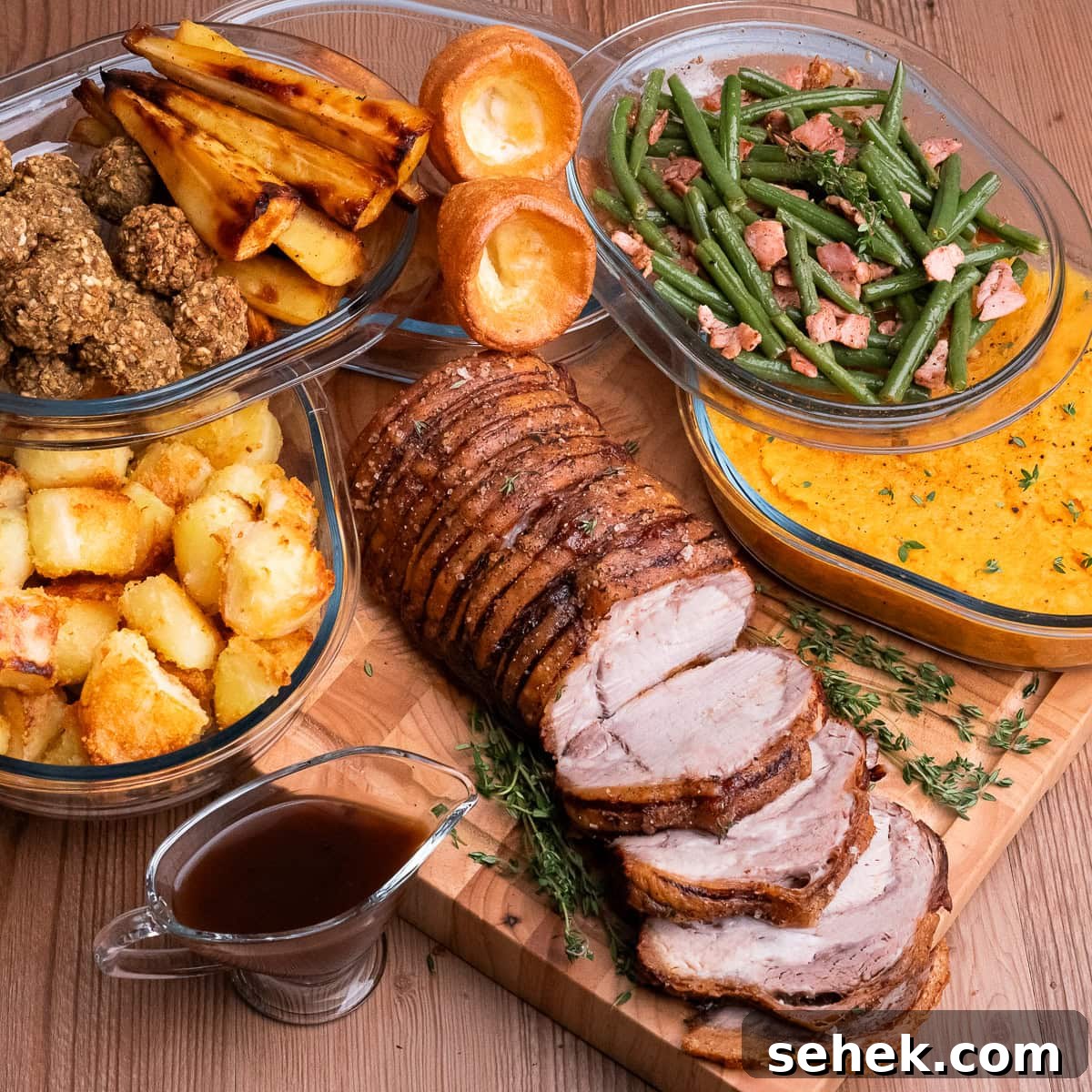 Garlic Green Beans with Crispy Bacon and Lemon Zest 32 Garlicky Green Beans and Bacon in a glass dish served with Pork loin joint sliced on a board served with roast dinner trimmings roast potatoes, sage and onion stuffing balls, honey roast parsnips, Yorkshire puddings, and buttered swede and carrot mash
