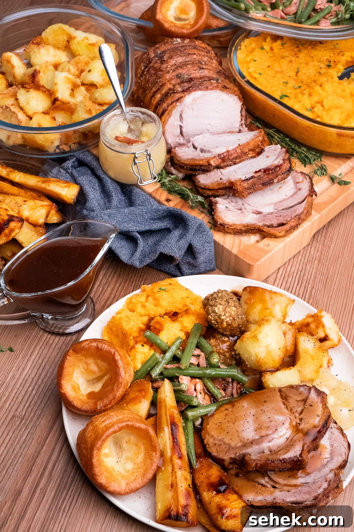 Garlic Green Beans with Crispy Bacon and Lemon Zest 33 Garlicky Green Beans and Bacon served with a roast pork dinner which consists of two slices of Roast Pork Loin, apple sauce, roast potatoes, Yorkshire puddings, honey roast parsnips and buttered swede and carrot mash