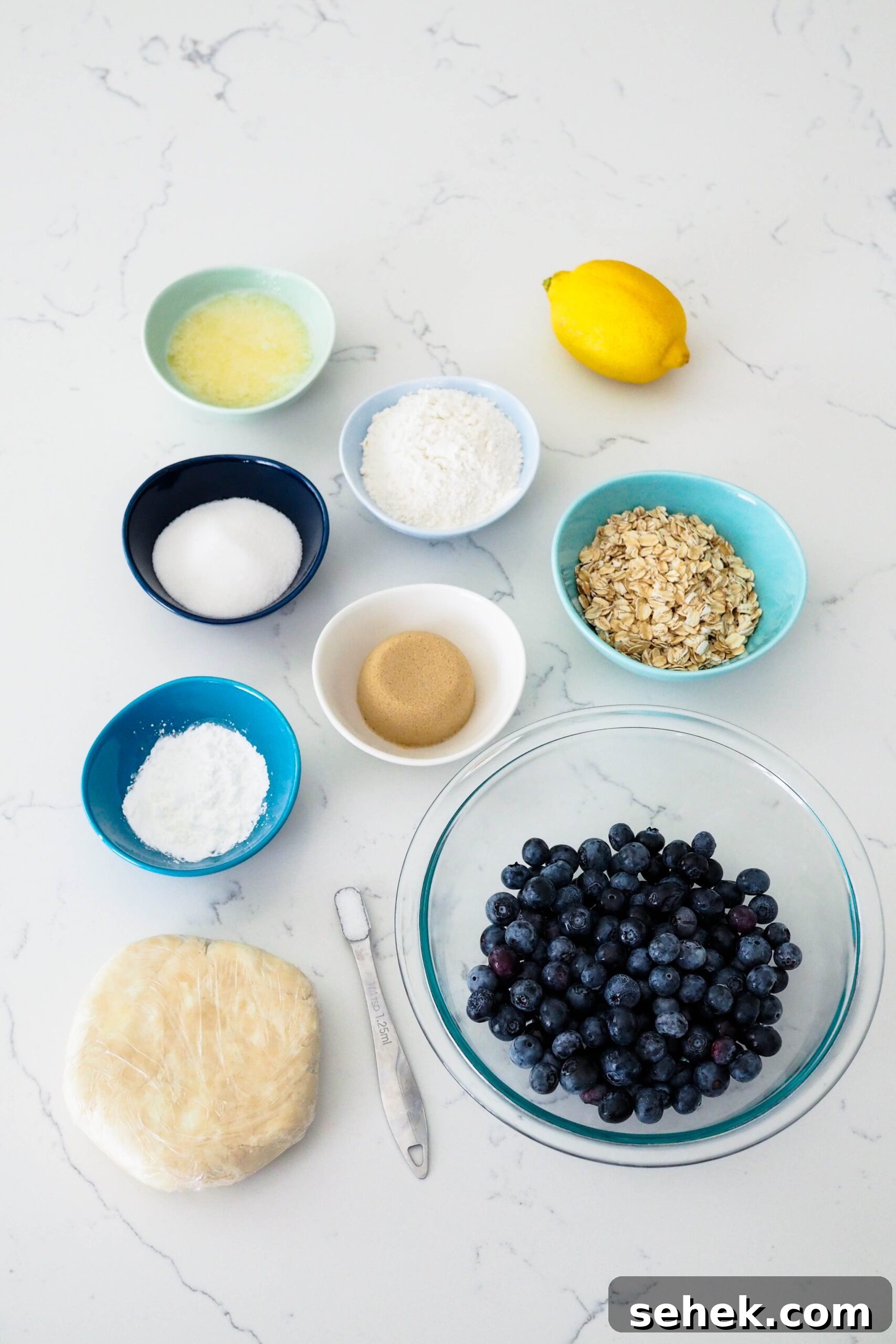 Mini Blueberry Hand Pies: Bite-Sized Fruit Desserts for Any Occasion 3 Ingredients for mini blueberry pies laid out on a counter.