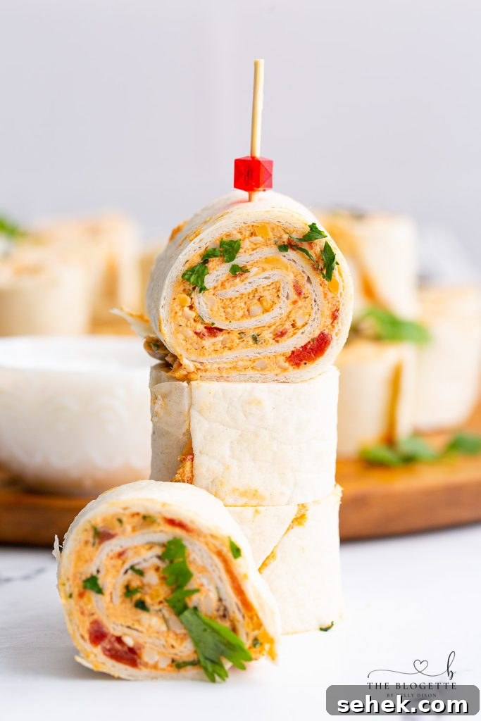 Chicken Enchilada Roll Ups are the perfect appetizer or snack for any party or occasion. This make-ahead appetizer is made with easy-to-find ingredients like taco seasoning, cream cheese, and shredded chicken (or leftover chicken!).