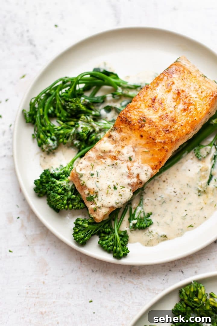 Creamy Dill Salmon Recipe with Lemon and Garlic 2 creamy dill salmon plated with broccolini and lots of sauce