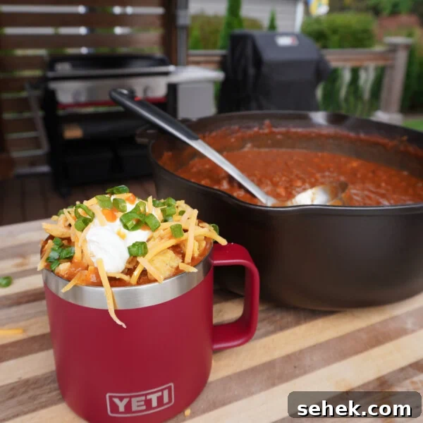 Over the top chili in a Yeti mug with all the toppings.