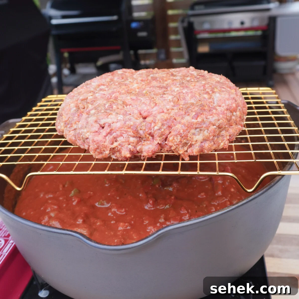Loaded Beef Chili Recipe: Over-the-Top Comfort Chili 6 beef patty on a wire rack over the chili mix.