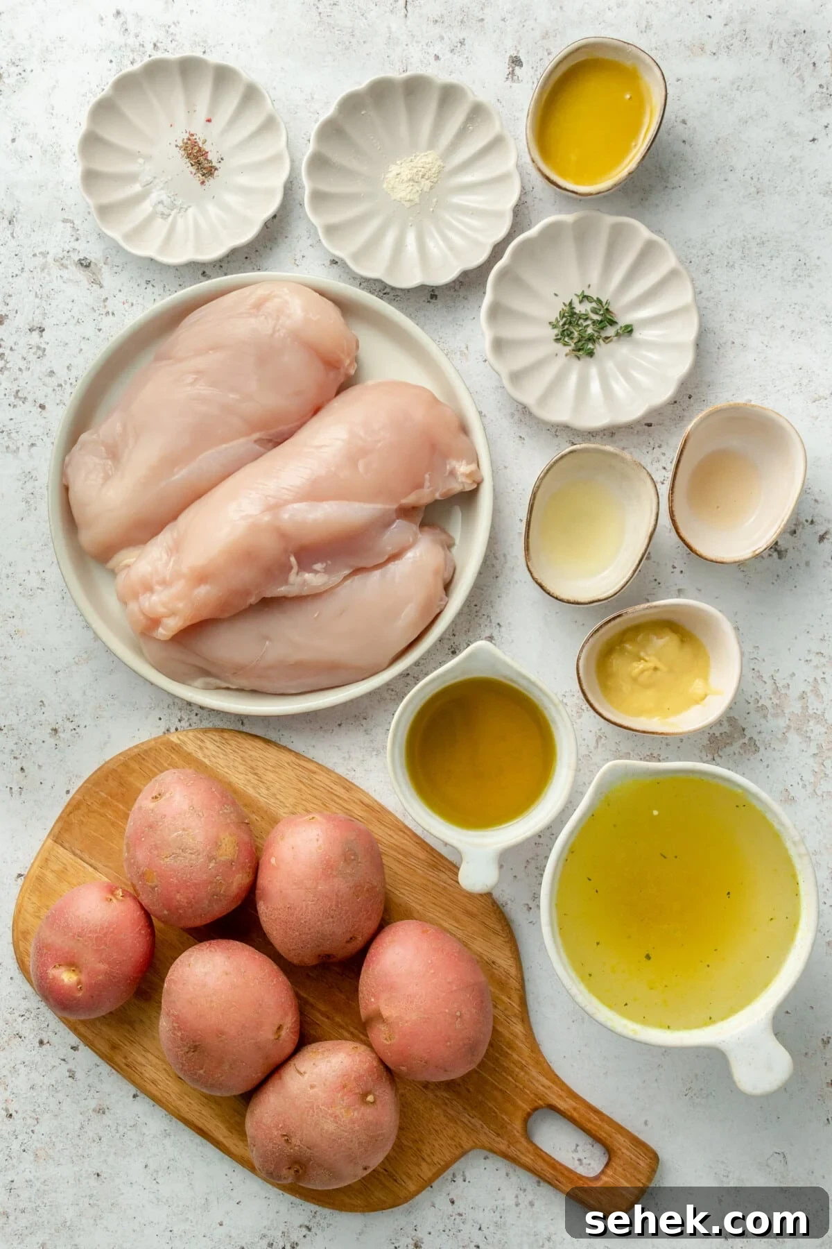Instant Pot Honey Mustard Chicken with Roasted Potatoes 3 Ingredients for honey mustard chicken laid out in small plates and bowls on a white background
