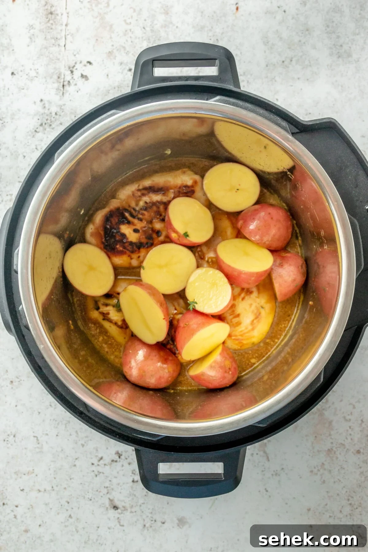 Instant Pot Honey Mustard Chicken with Roasted Potatoes 7 Red potatoes layered over chicken in an Instant Pot