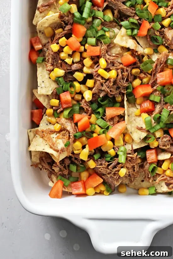Dairy-Free Nachos Recipe: Crispy, Cheesy Vegan Nachos 4 Unbaked nachos in a white baking dish.